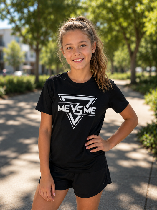 Young girl wearing a black 'ME VS ME' t-shirt outdoors
